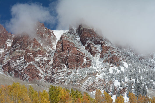 Snow-dusted Rocky Mountains with autumn foliage
