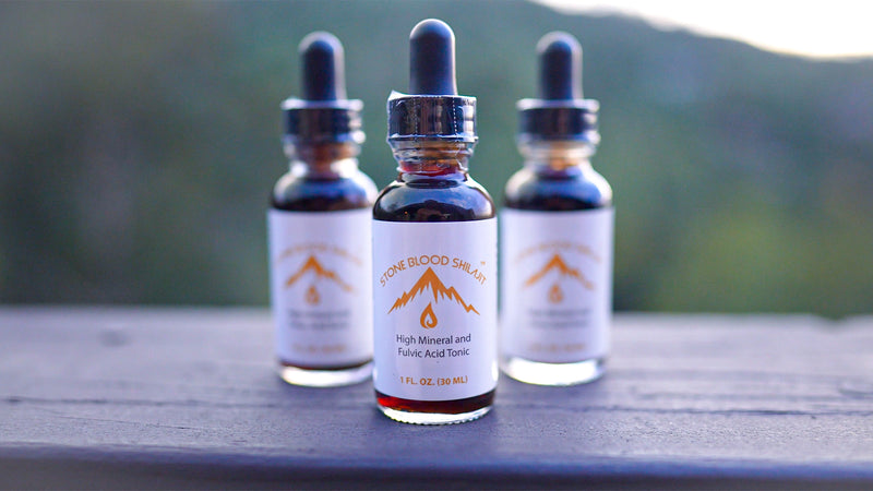Three Stoneblood Shilajit bottles photographed outdoors